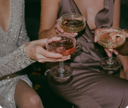 A group of women holding champagne glasses at a party.