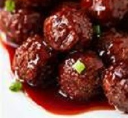 Chinese meatballs with sauce on a white plate.