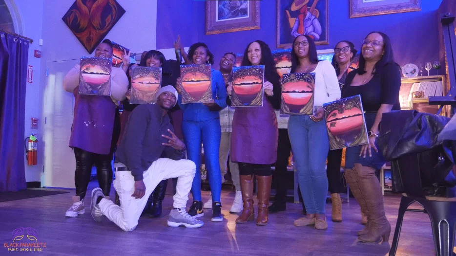 A group of people posing for a picture in a purple room.