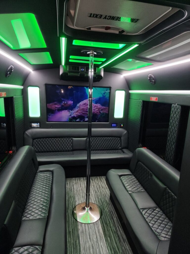 The interior of a party bus is lit up with green lights.