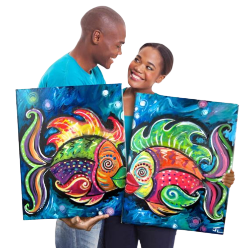 A man and woman holding up two fish paintings.