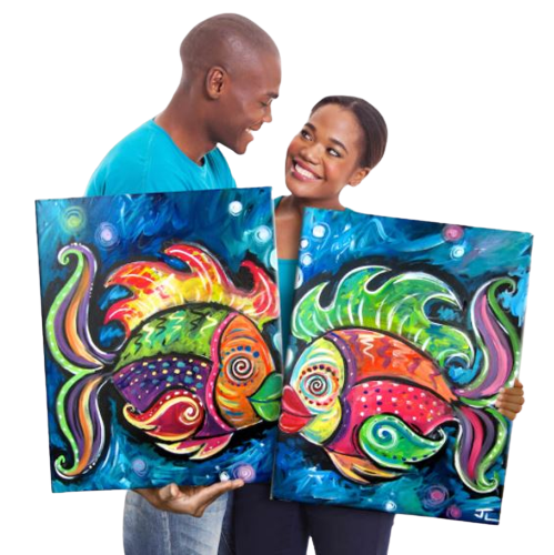 A man and woman holding up two fish paintings.