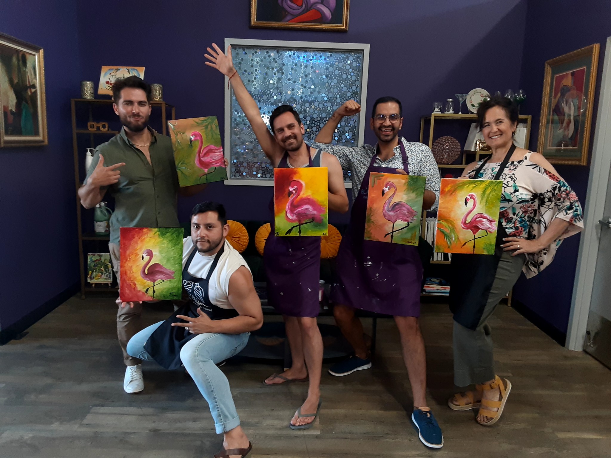 A group of people posing for a picture in an art studio.