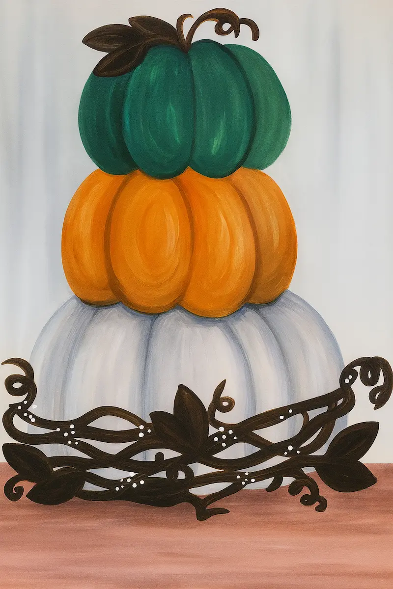 Stacked pumpkins with a decorative black vine at the base.